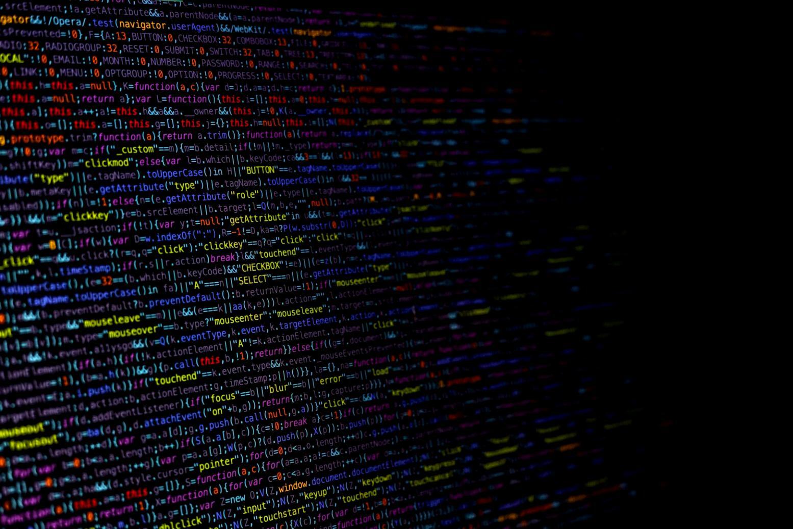 Close-up view of collaborative workspace with design sketches and web development tools