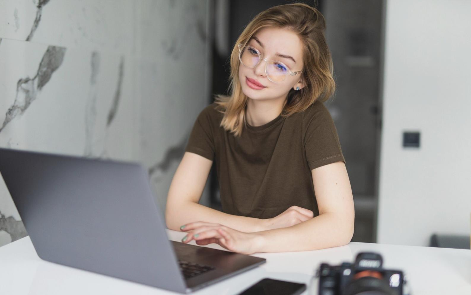 Students collaborating on web design projects in modern learning environment