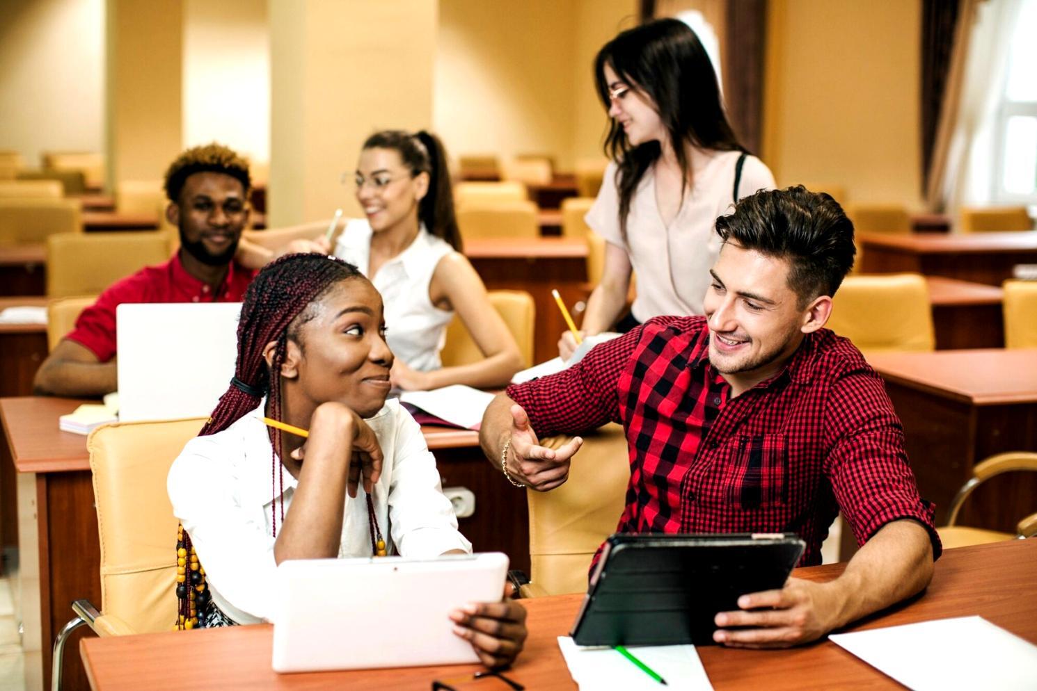 Modern web design workspace with multiple monitors showing responsive layouts